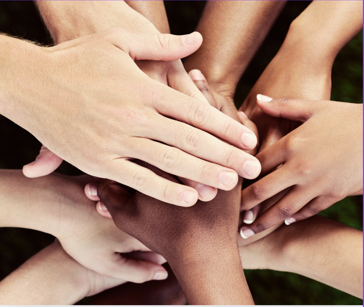 a group of people putting their hands together in a circle
